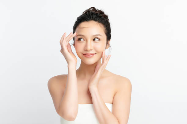 Beautiful young asian woman with clean fresh skin on white background, Face care, Facial treatment, Cosmetology, beauty and spa, Asian women portrait. Beautiful young asian woman with clean fresh skin on white background, Face care, Facial treatment, Cosmetology, beauty and spa, Asian women portrait. facial mask stock pictures, royalty-free photos & images