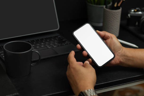 istock A man hands holding smartphone or mobile phone on a desk 1359069869