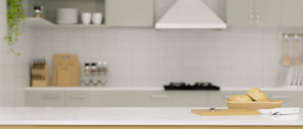 istock Modern white kitchen countertop with bread in a basket, chopping board and copy space 1359069876