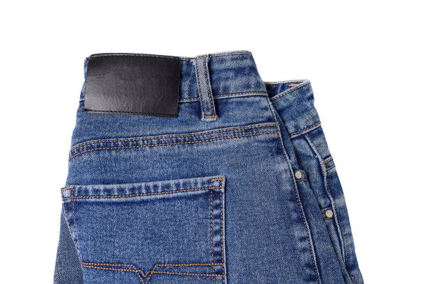 istock Neatly folded blue jeans on a white background, ready for layout 1359070015