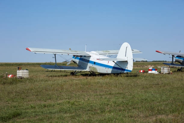 istock An old Soviet plane white with a blue stripe is standing in a field at the airfield 1359070035