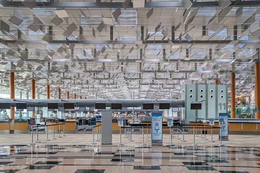 Singapore, Singapore - November 7, 2021: Row of closed check-in counters at Terminal 3, Changi Airport, Singapore.