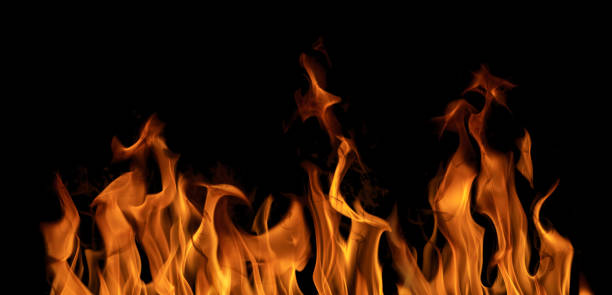 istock bright flame orange sparks isolated on black 1359073712