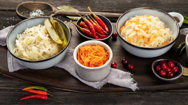 istock Pickled vegetables on wooden background. Salting vegetables. 1359075730