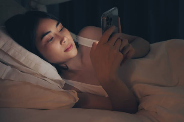 istock Woman are using phone on the bed before she sleeping at night. 1359076450