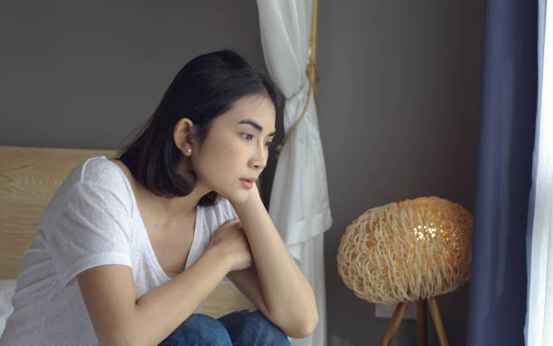 istock Sad thoughtful young woman pensive face looking away thinking of problems sit alone at home, feels unhappy, lost on unpleasant thoughts, suffering due life troubles. 1359076454