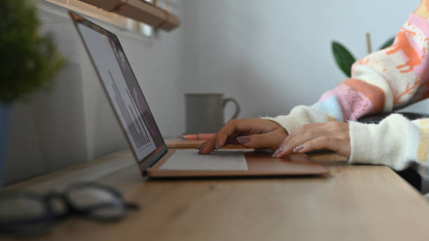 istock Close up view woman browsing internet with computer laptop. 1359076472