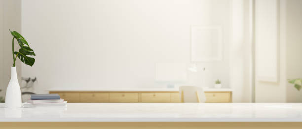 istock White tabletop with copy space over modern white working room in the background. 1359076584