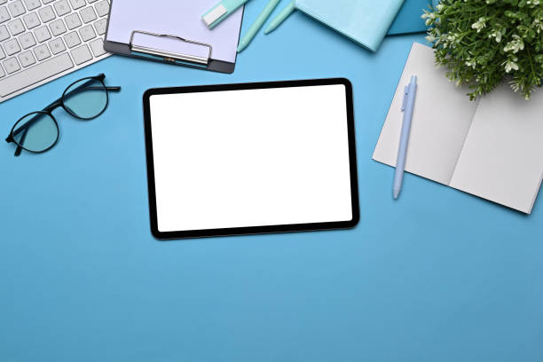 istock Top view Digital tablet with empty display, glasses and notebooks on lea background. 1359078544