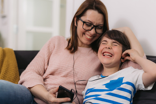 mother and son listening to a music at home