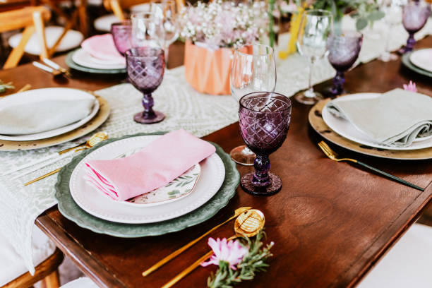 istock table setup with flowers, glasses and plates on table decorated for Wedding Reception in terrace Latin America 1359079643