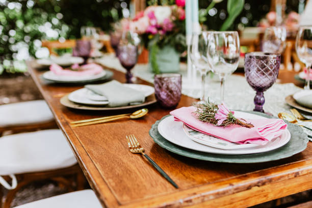 istock table setup with flowers, glasses and plates on table decorated for Wedding Reception in terrace Latin America 1359079738