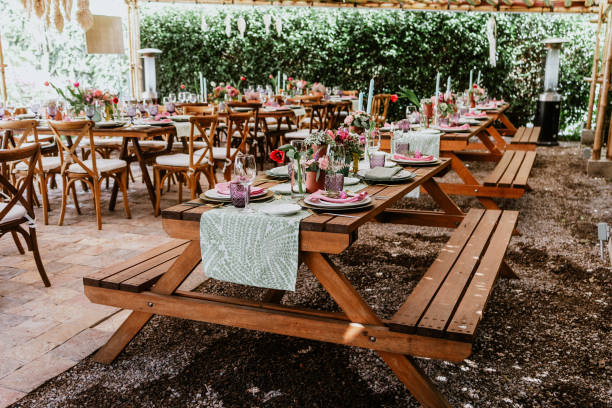 istock terrace with tables setup with flowers and plates on table decorated for Wedding Reception in Latin America 1359079944