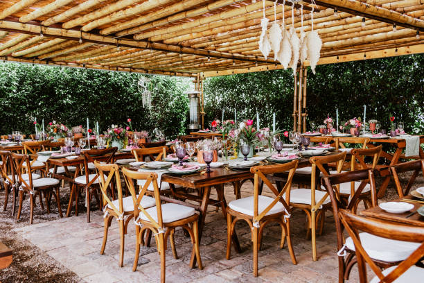 istock terrace with tables setup with flowers and plates on table decorated for Wedding Reception in Latin America 1359079960