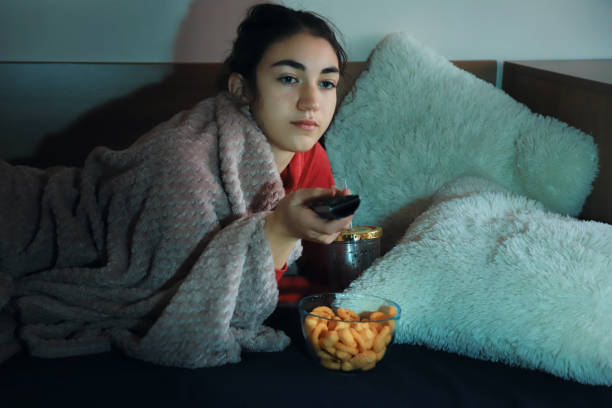 istock Girl watching TV 1359085132