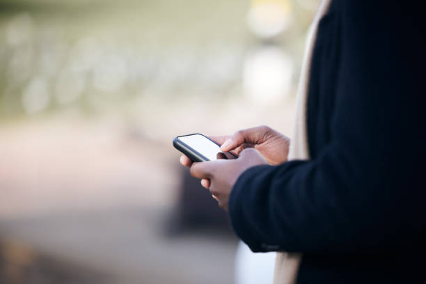 istock Shot of a unrecognizable business man using his cellphone outside 1359085284