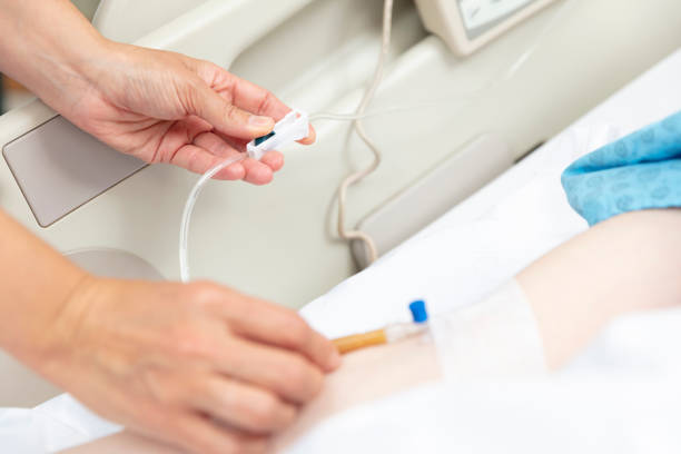 istock Female doctor opens vascular access to patient, 1359085911