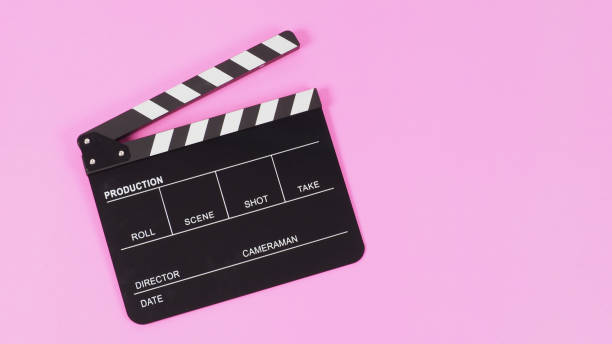 istock Black Clapper board or movie slate on pink background.