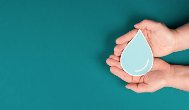 istock Hands holding a drop of water, paper cut out, environmental issue, copy space for text 1359092533