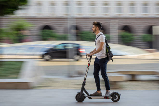 istock Young student bypassing traffic with electric scooter 1359092544