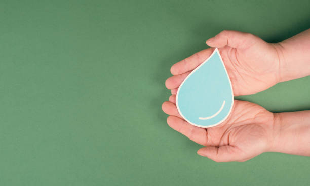istock Hands holding a drop of water, paper cut out, environmental issue, copy space for text 1359092589