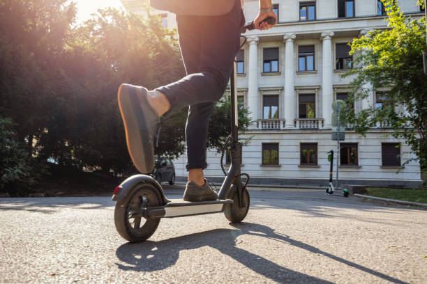 istock Man riding electric scooter in the morning 1359093367