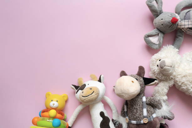 istock baby toys on a pink background.  view from above 1359093476