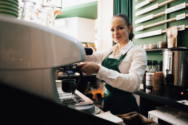 istock Caucasian female barista at work making coffee 1359093536