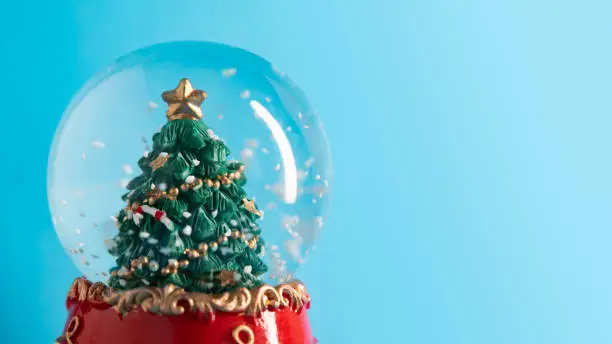 Photo of Christmas tree in a crystal ball with snow