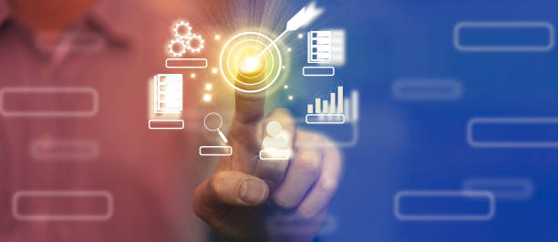 istock business man finger choose target dart aim option button amoung grae graph chart and goal success strategy achieve way by use technology in marketing competition and great performance 1359096107