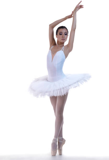 istock Ballet Dance Concepts. Professional Japanese Female Ballet Dancer Posing in White Tutu With Lifted Hands Against White Background. 1359097732