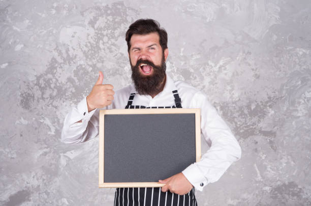 istock Man good looking hospitable restaurant waiter with blackboard copy space, special recipe concept 1359097803