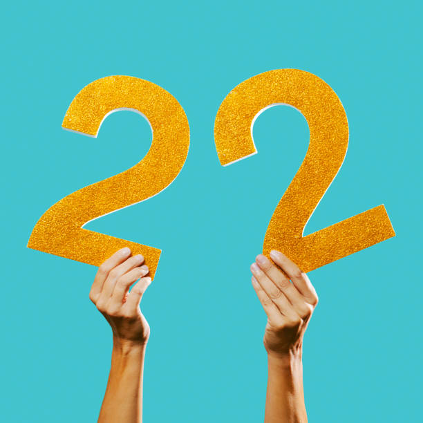 istock man shows the number 22 in his hands 1359098129