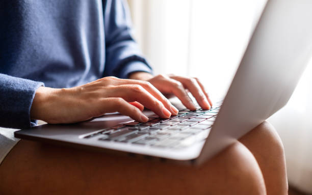 istock Closeup of a woman working and typing on laptop computer keyboard 1359098791