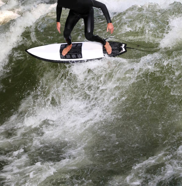 istock surfer balancing on surfboard with waves seen from above 1359102245