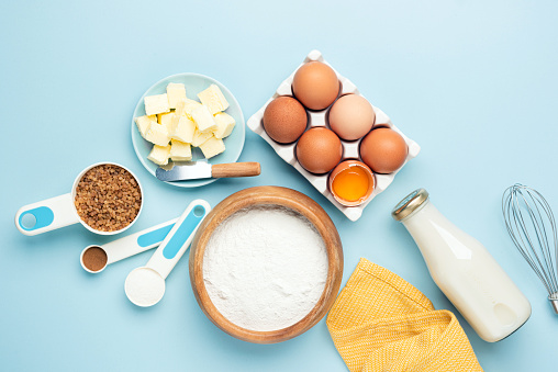 Ingredients For Baking On A Blue Background, top view. Flat Lay