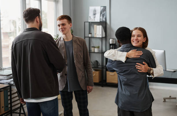 istock Employees greeting each other at office 1359104066