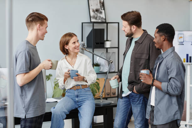 istock Business people drinking coffee and talking 1359104084