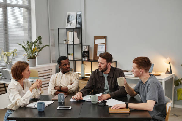 istock Business people sitting at meeting 1359104095