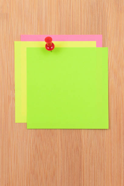 istock Colored Sticky Notes Pinned to the Wooden Message Board 1359105370