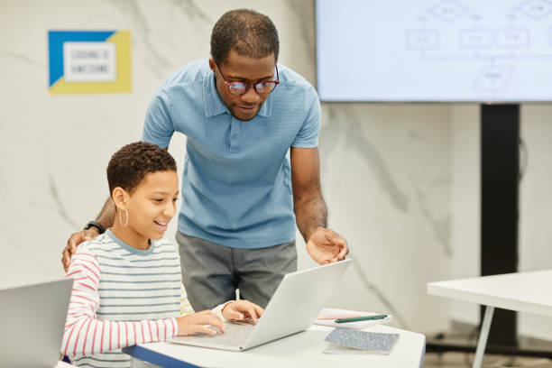 istock African American Teacher Helping Student in Class 1359107275