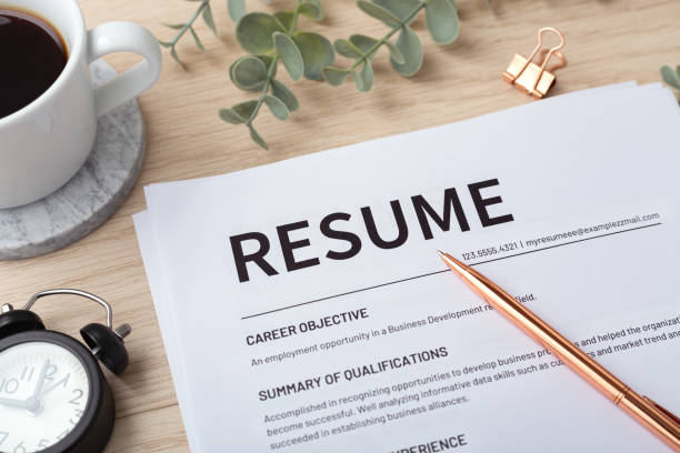 istock Resume with pen and  coffee cup, closeup 1359108626