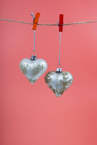 istock Christmas balls hearts on a pink background. 1359109541
