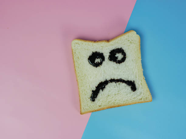istock white bread with sad emoticon on blue and pink pastel background 1359110361