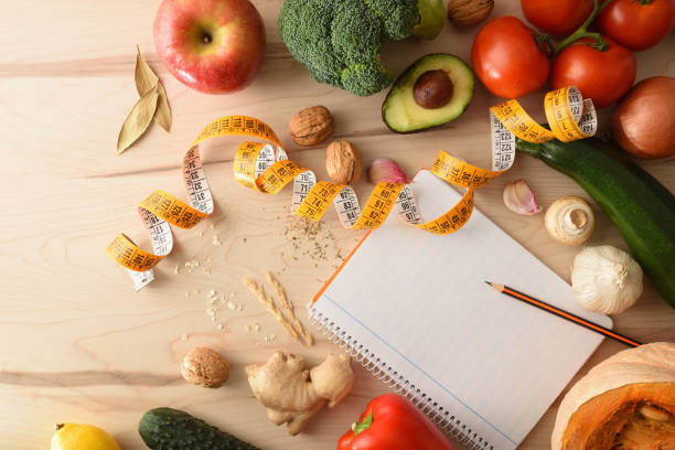 istock Healthy food metric tape and notebook for aiming on table 1359111608