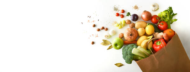 istock Background shopping bag with fruits and vegetables on white table 1359111636