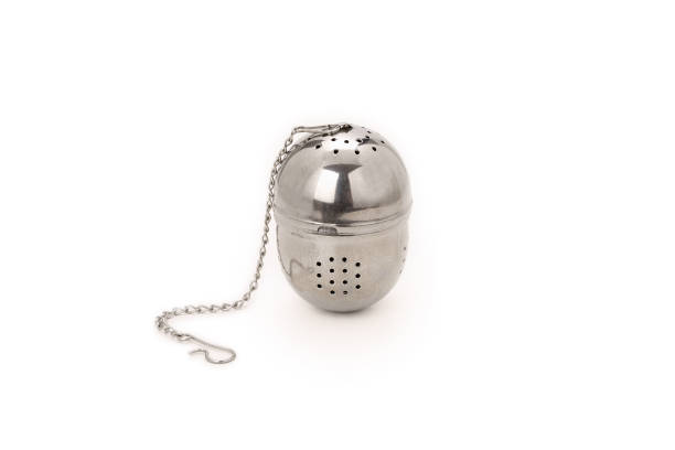 istock Front view of a stainless steel tea infuser isolated on completely white background. 1359112209