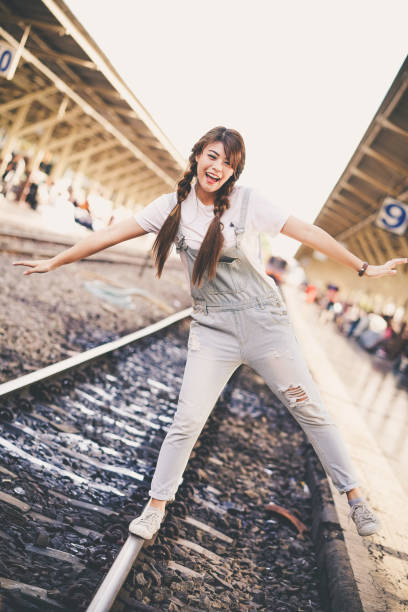 istock asian young girl journey backpack adventure by train. 1359112307