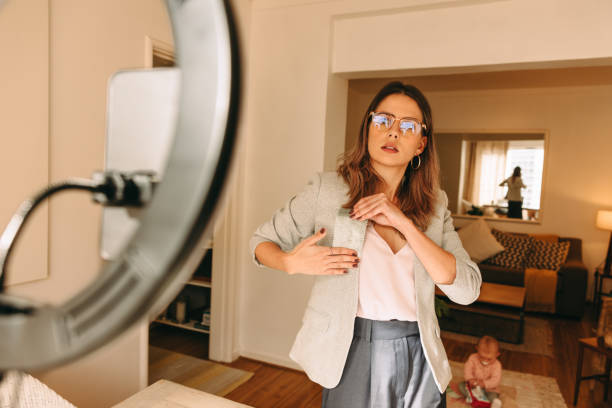 istock Freelance designer holding a fabric swatch while recording a video 1359113570