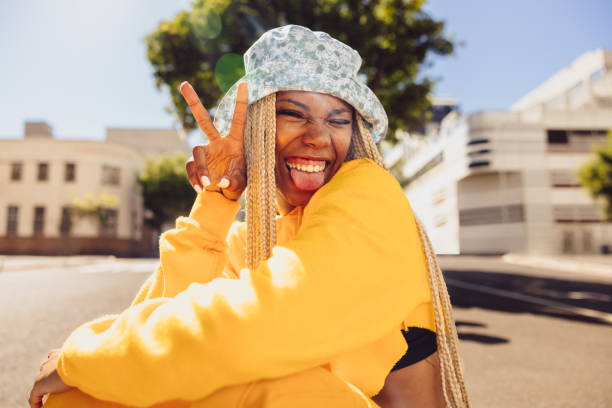 istock Carefree young woman making the peace sign 1359114921